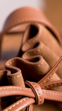 Macro Detail of Brown Leather Bucket Bag Drawstring and Pleats