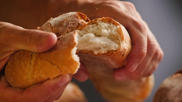 Baguette Bread torn apart by hand, fresh baguette crumb close-up macro shot showing soft airy texture