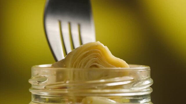 Artichoke hearts marinated in glass bowl, traditional Catalan vegetable appetizer, close-up macro shot