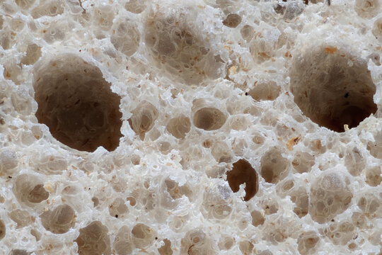 Close look at bread texture showing holes and bubbles from fermentation process in kitchen