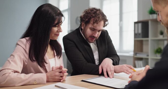 Interview recruiters managers candidate meeting discussion resume. Two recruiters review resume with a candidate in office, assessing fit and communication. Clear professional recruitment concept.