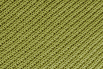 Close up, macro of khaki knitted fabric texture with visible diagonal yarn stitches and soft wool pattern. Cozy textile backdrop, cloth background, fashion wallpaper, winter clothing concepts © katyamaximenko