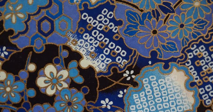 Traditional Japanese Patterns &ndash; Blue Floral and Geometric Design in Motion - Traditional Japanese patterns featuring blue floral and geometric motifs with gold accents, shown with smooth horizontal ca