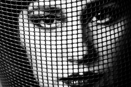 Face of Girl Behing a Net on a Dark Background. Fine - Art Photography
