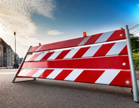 red and white striped construction barrier board