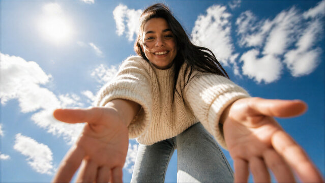 Happy Woman in White Sweater Reaching Hands Down Toward Camera, Helping Perspective POV, Sunny Blue Sky Background