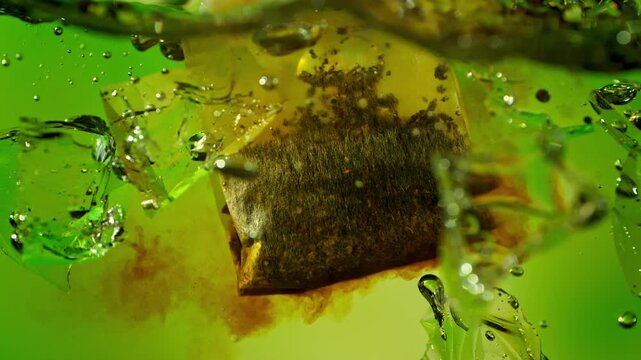 Super Slow Motion of Extracting Tea Bag in Water with Ice at 1000fps, Ice Tea Concept.