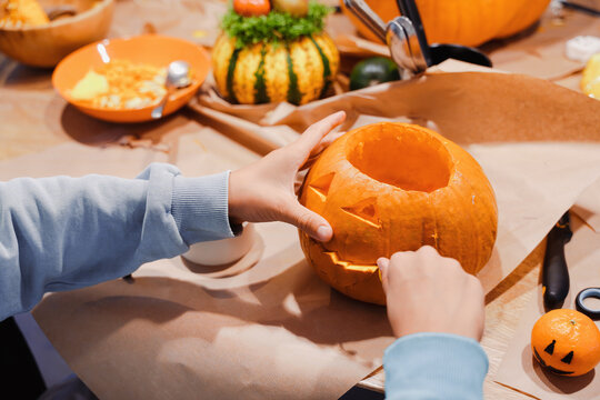 Children Scooping Pumpkin During Halloween Carving Workshop