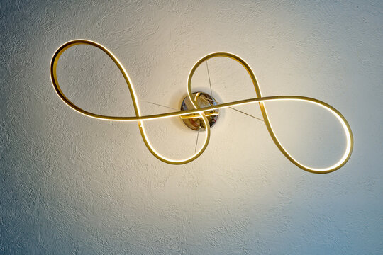 A twisted and illuminated LED ceiling lamp fixture upward