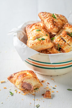 Fresh and delicious sausage roll with tatar sauce and herbs.