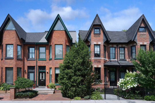 Street of narrow Victorian semi-detached houses with gables, renovated and gentrified