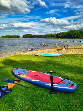 Stand up paddle board on a sunny lake in Poland