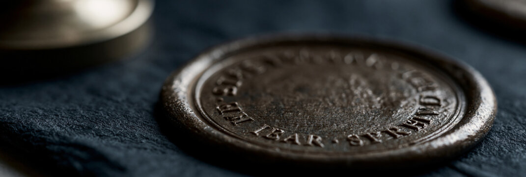 Close-up of an antique wax seal, showcasing intricate details and texture.