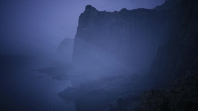 Foggy shoreline plateau with scattered rocks, low plateau leading to turbulent sea edge, scattered boulders and pebble beds, quiet blue haze and tactile rock