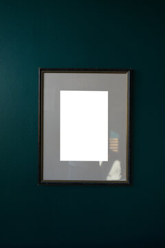 Vintage picture frame mockup on dark teal wall