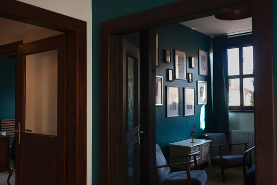 Stylish sitting room through doorway with teal gallery wall