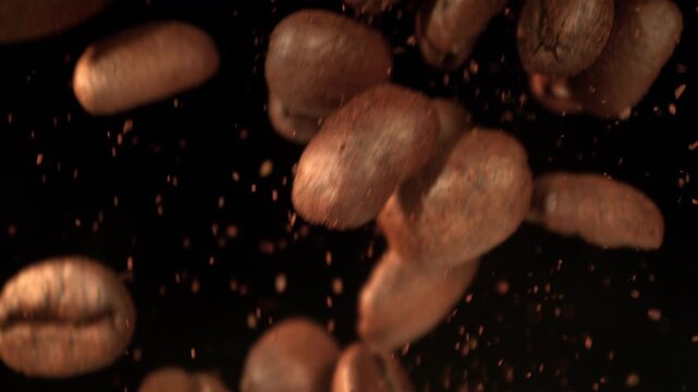 Super Slow Motion Shot of Falling Coffee Beans and Ground Coffee Isolated on Black at 1000fps.