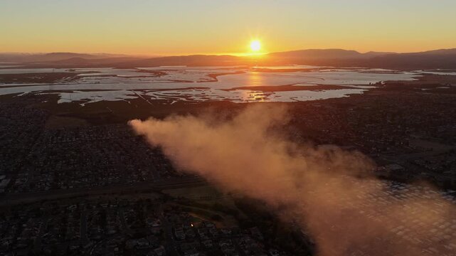 AMERICAN CANYON, CA - JULY 25, 2026: High-angle aerial of a wind-driven smoke plume from the Dutch Flat Fire streaming across town toward San Pablo Bay at sunset, Napa County, California.