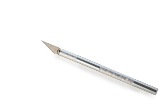 Crafting precision with a sharp metal tool on a clean white surface
