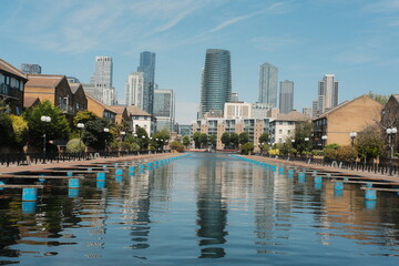Waterfront promenade with modern city skyline and mooring buoys © engelandapostol