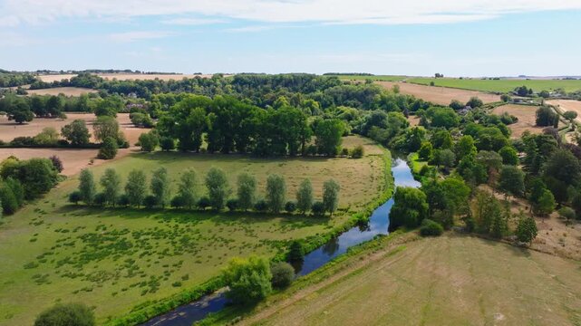 Aerial shot flying along the River Avon in the Woodford Valley towards Heale House in summer, Wiltshire, UK