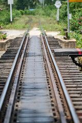 Fototapeta premium old railway tracks at the bridge over the river kwai