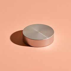 Fototapeta premium Single brushed metal paperweight on a seamless soft pastel peach backdrop
