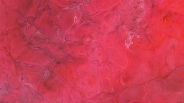 Paint spreads in water as it mixes with ink in an underwater scene