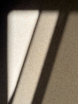 Abstract background of light and shadows on a speckled surface