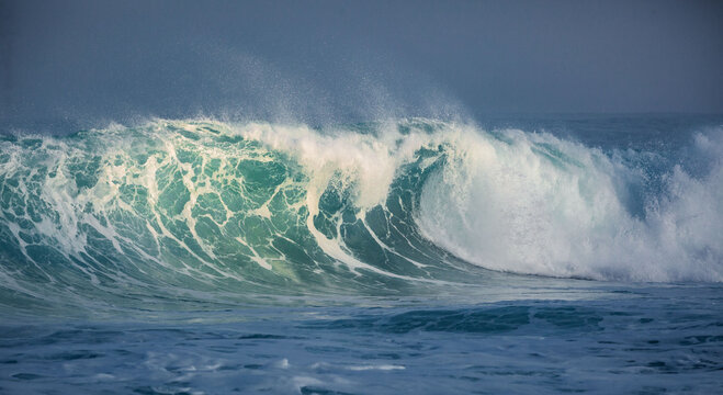 Powerful Turquoise Ocean Wave Cresting and Breaking in Deep Blue Sea