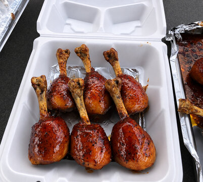 Glazed BBQ Chicken Lollipops in a Styrofoam Takeout Container