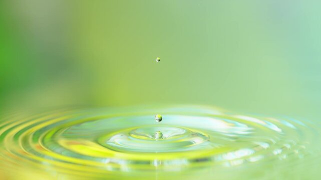 Super Slow Motion Shot of Water Drop Falling into Water Surface at 1000fps.