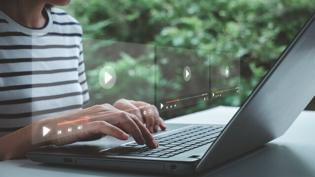 Person using laptop with digital video streaming interface, online entertainment, media consumption, content delivery, remote learning, virtual communication, technology, modern digital lifestyle.