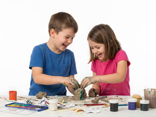 Obraz premium Joyful children happily creating art with clay and paints on a white background