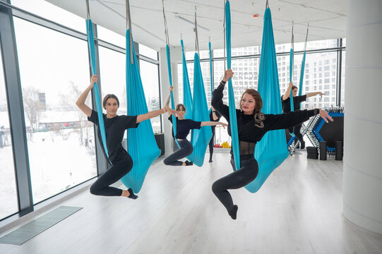 Group yoga class on hammocks. 