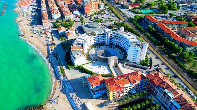PORTO RECANATI, ITALY - JULY 30, 2025: Aerial top-down bird's-eye pullback shot of the beach. Porto Recanati's seaside amenities offer something for everyone, complete with Adriatic Sea lush waters