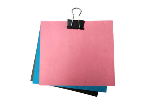 Pink sticky note attached with binder clip on colorful notes stack
