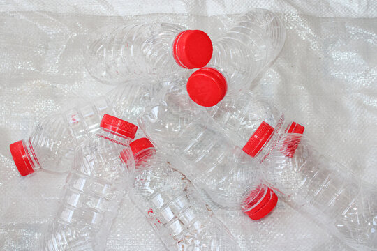 Pile Of Empty Plastic Bottles With Red Caps For Recycling