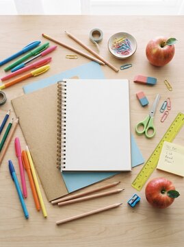 Flat lay of school supplies with an open notebook and colorful stationery