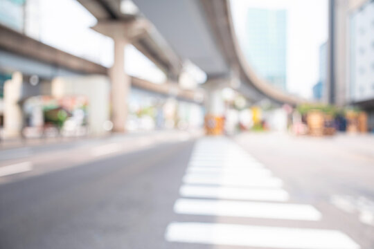 Abstract blurred modern urban avenue background with curved overpass and crosswalk