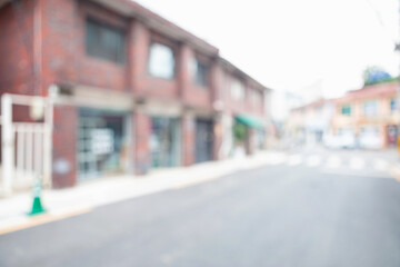 Fototapeta premium Abstract blurred urban residential street background with old red brick buildings