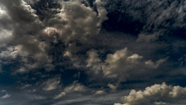 Dark rain cloud dramatic sky summer tropical thunder storm sky and fluffy black darkness cloud nearly raining cloudscape. Dark gray sky cloudy environment. Nimbus raincloud skyline climate background