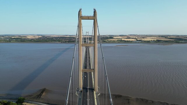 Drone aerial symmetrical pull back shot of the historic Humber Bridge in Yorkshire