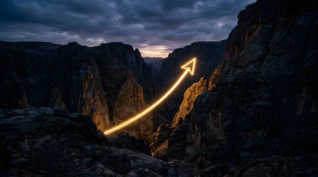 Glowing yellow arrow rising over rocky mountain canyon at twilight