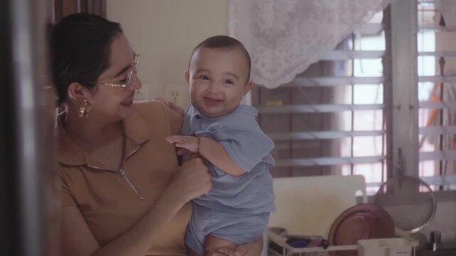 Affectionate mother holding her smiling son
