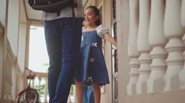 Father returning home greets his loving family