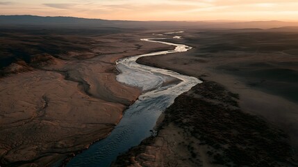 Fototapeta premium Winding Desert River at Sunset with Salt Flat