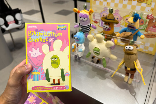 PENANG, MALAYSIA - JUL 03, 2026: Hand holding SpongeBob SquarePants Bikini Bottom Buddies blind box inside Pop Mart retail store.