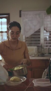 Mother serving dinner in a warm kitchen