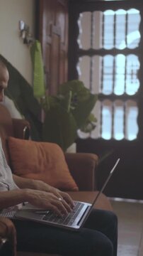 Person working remotely on laptop from home